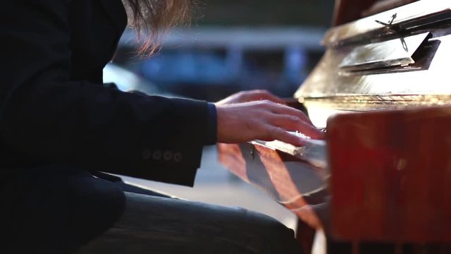 Old Man Playing the Piano in the City