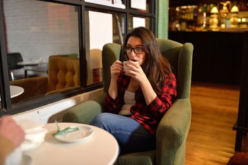 Young beautiful woman having coffee