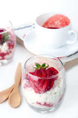 Glass of ripe strawberries with cream