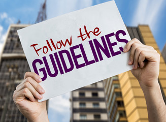 Follow the Guidelines placard with urban background