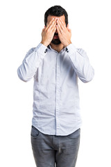 Man covering his eyes