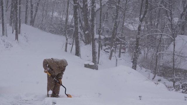 View Of A Man Shoveling Snow