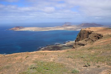 Fototapeta na wymiar On a high plateau of the Chinijo Archipelago nature park, Lanzarote, Canary Islands. View of the island La Graciosa.