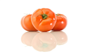 Three pink tomato on a white background