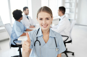 Fototapeta premium happy doctor over group of medics at hospital