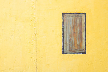 Vintage window on yellow cement wall can be used for background