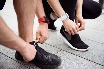 Man and woman tying their shoelaces