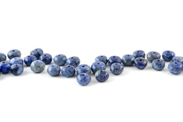 Gemstone natural lapis lazuli on white background, beads