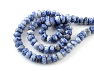 Gemstone natural lapis lazuli on white background, beads