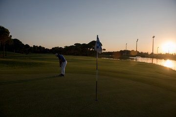 golfer hitting ball to hole