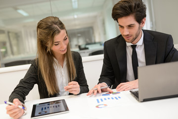 Business people working around table in modern office