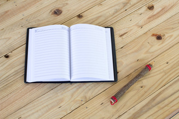 Pencil and a notebook on a table Photo of a Pencil and a noteboo