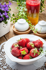 Fresh strawberries in white bowl.