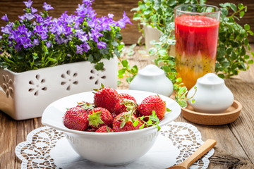 Fresh strawberries in white bowl.