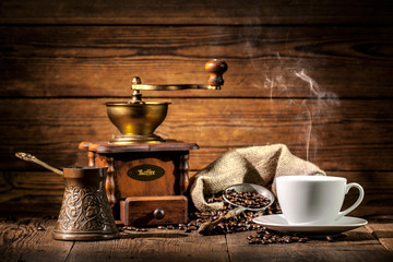 Coffee grinder, turk and cup of coffee