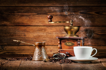 Coffee grinder, turk and cup of coffee