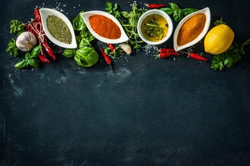 Fototapeten Herbs and spices over black stone background © Alexander Raths