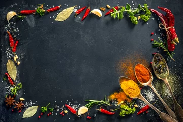 Poster Herbs and spices over black stone background © Alexander Raths