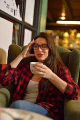 Young beautiful woman having coffee