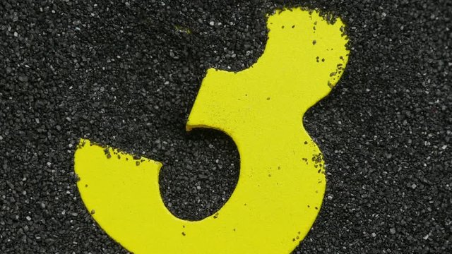 Three. Wooden number find in sand. For creation countdown.