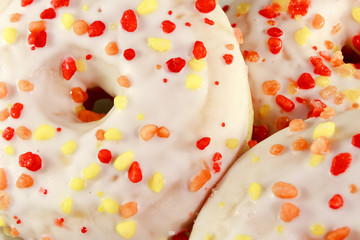 Closeup of donuts decorated with colourful sprinkles