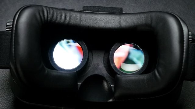 Virtual reality mask. Male hand taking a virtual reality headset.