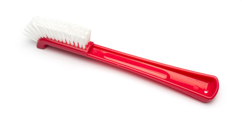 red plastic brush on a white background