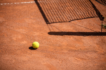 Tennis balls on the ground of clay court