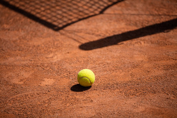 Tennis balls on the ground of clay court