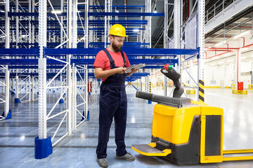 Warehouse worker in a yellow helmet