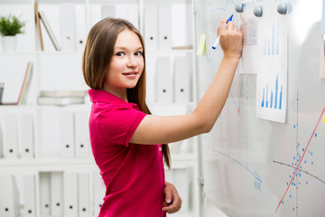 Causal woman drawing business charts