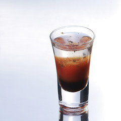 Colorful layered shot isolated on white gray gradient background with reflection. Alcohol shooter