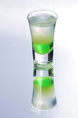 Colorful layered shot isolated on white gray gradient background with reflection. Alcohol shooter