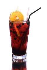 Berry and orange cold cocktail in big glass isolated on white background with reflection