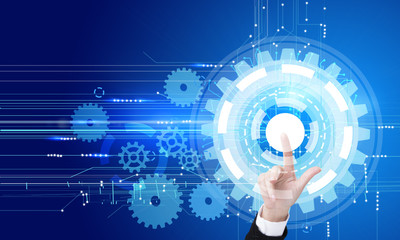 Hand pointing at cogwheel pattern
