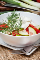 Fresh salad in white bowl.