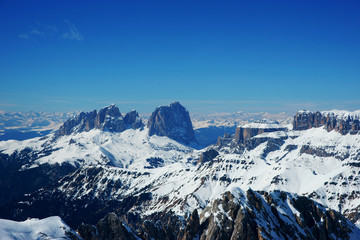 Scenic view on snowy peaks in italian dolomiti alps on a sunny day. Arabba Marmalada 