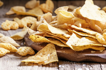Mexican corn chips, nachos with salt, vintage wooden background,