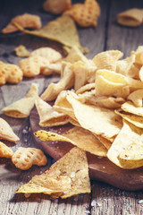 Mexican corn chips, nachos with salt, vintage wooden background,