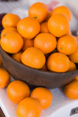 Oranges in wooden bowl. Healthy fruit food and snack.