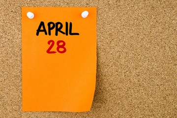 28 APRIL written on orange paper note