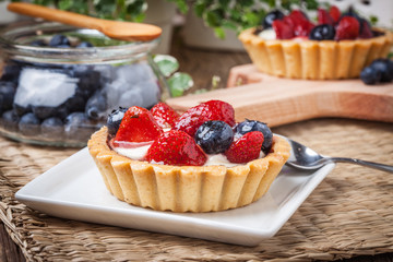 Fresh homemade fruit tart with strawberries and blueberries.