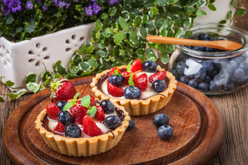 Fresh homemade fruit tart with strawberries and blueberries.