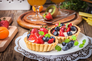 Fresh homemade fruit tart with strawberries and blueberries.