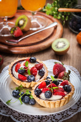 Fototapeta na wymiar Fresh homemade fruit tart with strawberries and blueberries.