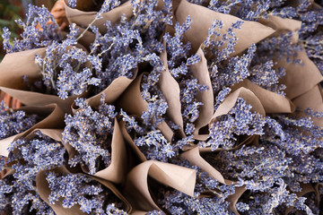 Top view on beautiful fresh lavender flowers in the basket on the street market. Bunches of lavender in craft paper. Romantic flowers.