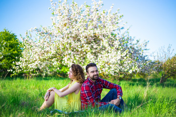 beautiful couple in love sitting in park