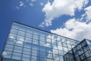 Fototapeta na wymiar Building facade with blue sky and white clouds
