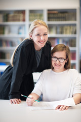 female teacher helping students on class