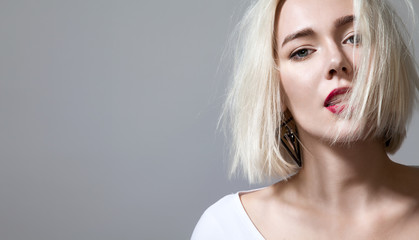 Close up face woman with red lips and sensual look on a grey background isolated